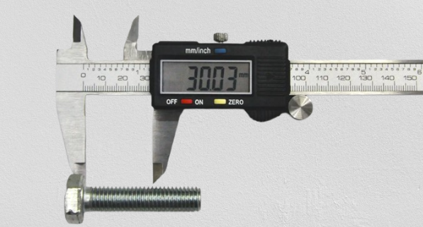 Fig. 6 Measuring the bolt with a caliper